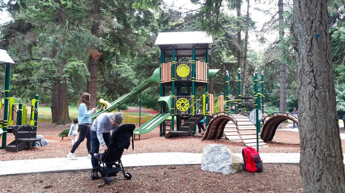 Kids and families play on the updated playground at Discovery Park, Seattle's largest park