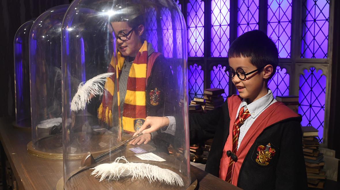 At Harry Potter: Magic at Play boys practice their wingardium leviosa spell in the Charms class at Hogwarts