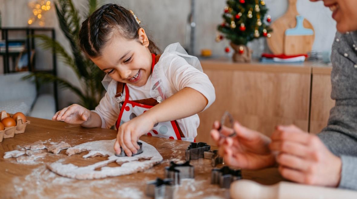 Young girl smiling making Christmas cookies
