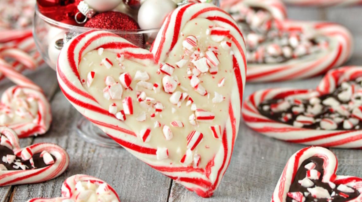Two candy canes together to form a heart with the middle filled in with white chocolate