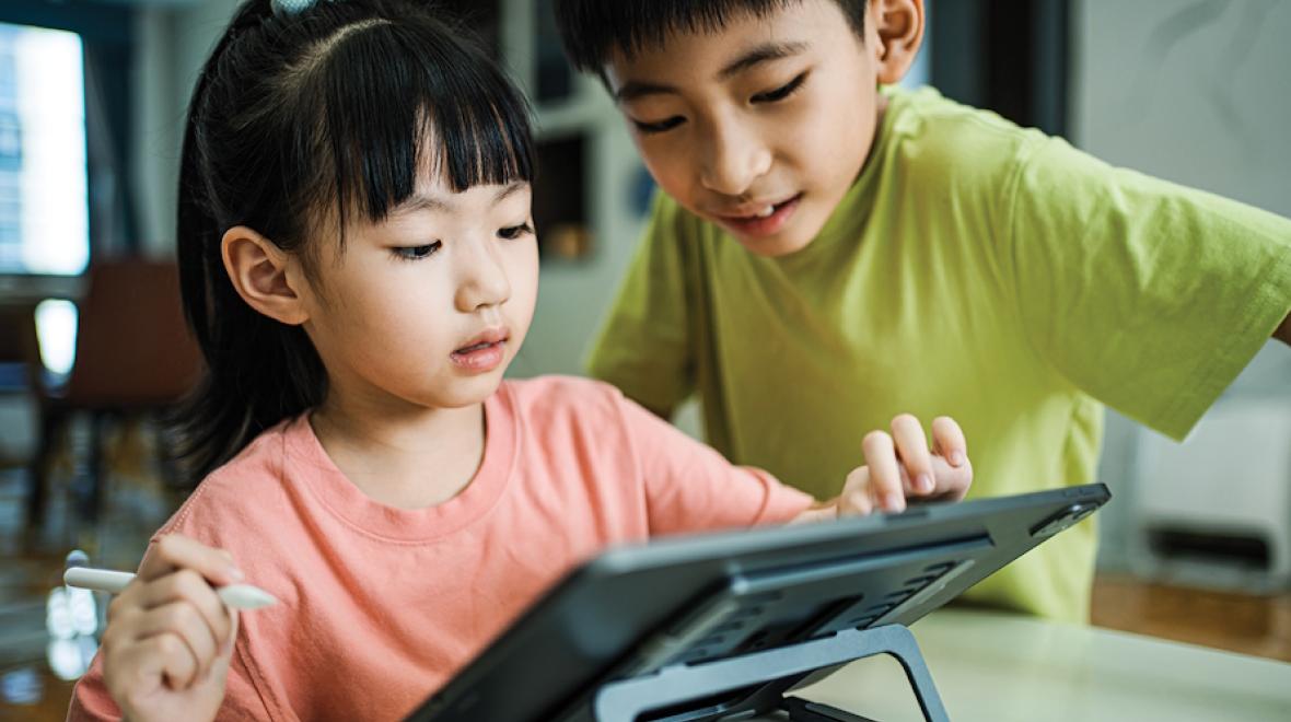 A boy and girl using a tablet together