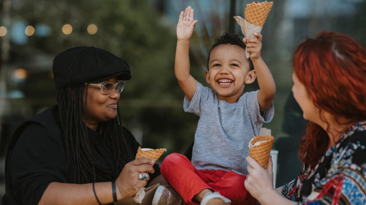 Little boy eating ice cream with his moms on a Seattle food tour