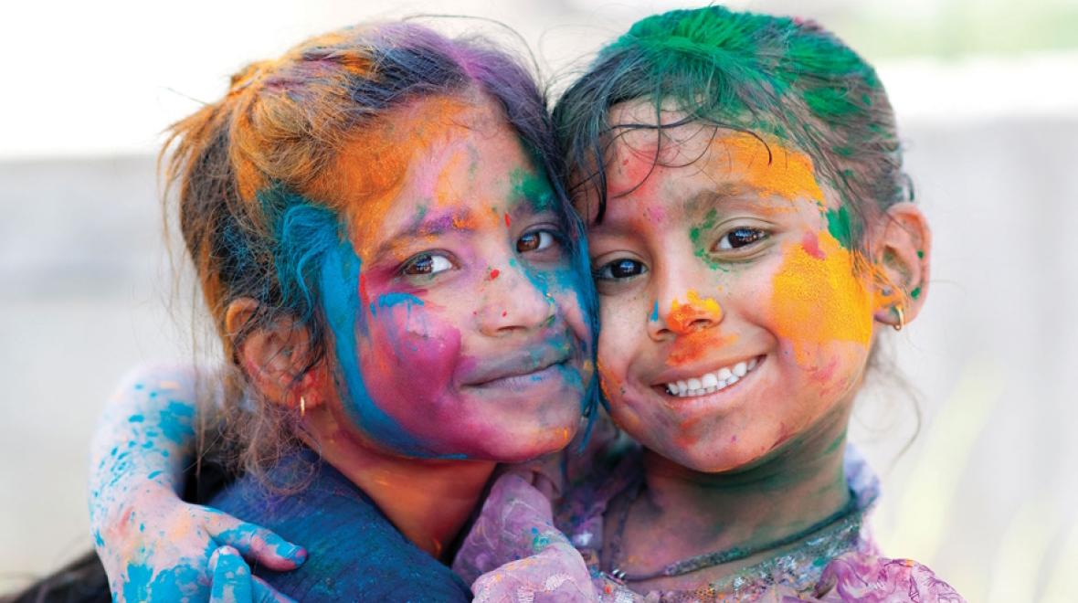 Two girls covered in colors at a Holi celebration