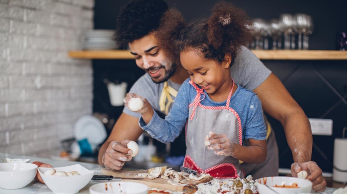 Dad and daughter cooking together spring break at home