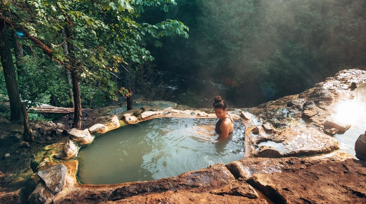 Woman relaxing in a hot spring in Oregon 