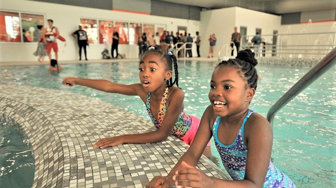 Two girls at the side of the indoor pool, People's Pool in Tacoma