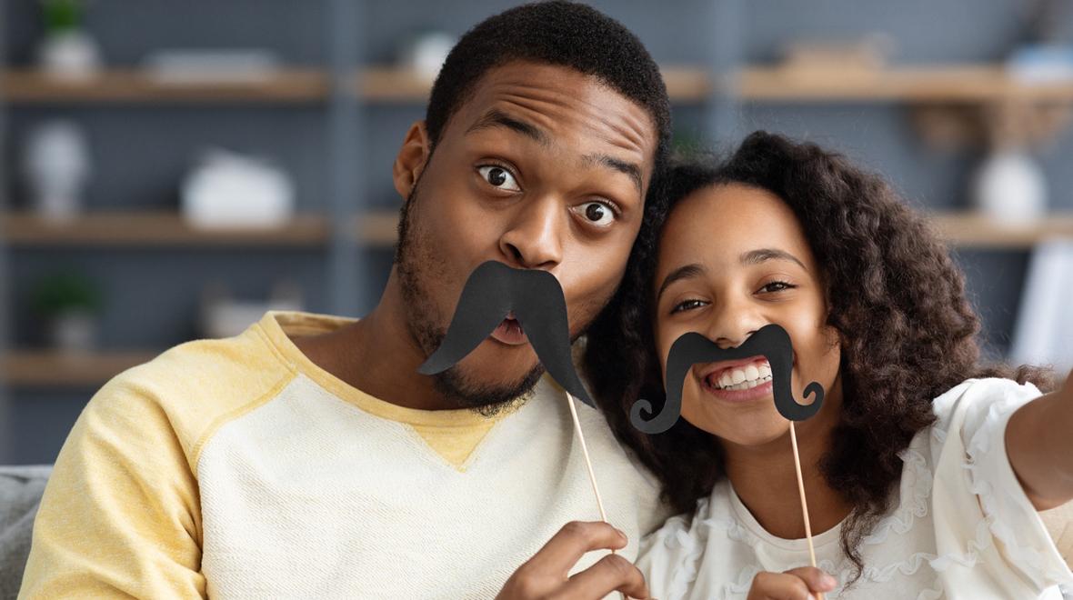 dad and daughter with paper mustaches 