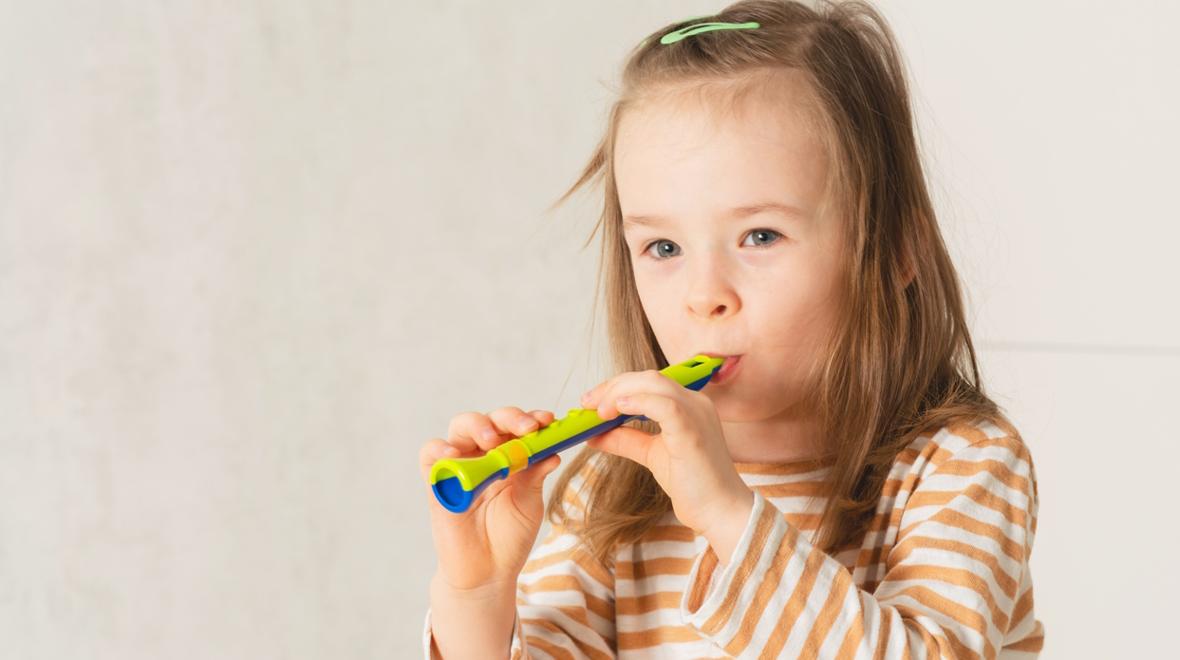 girl playing a whistle