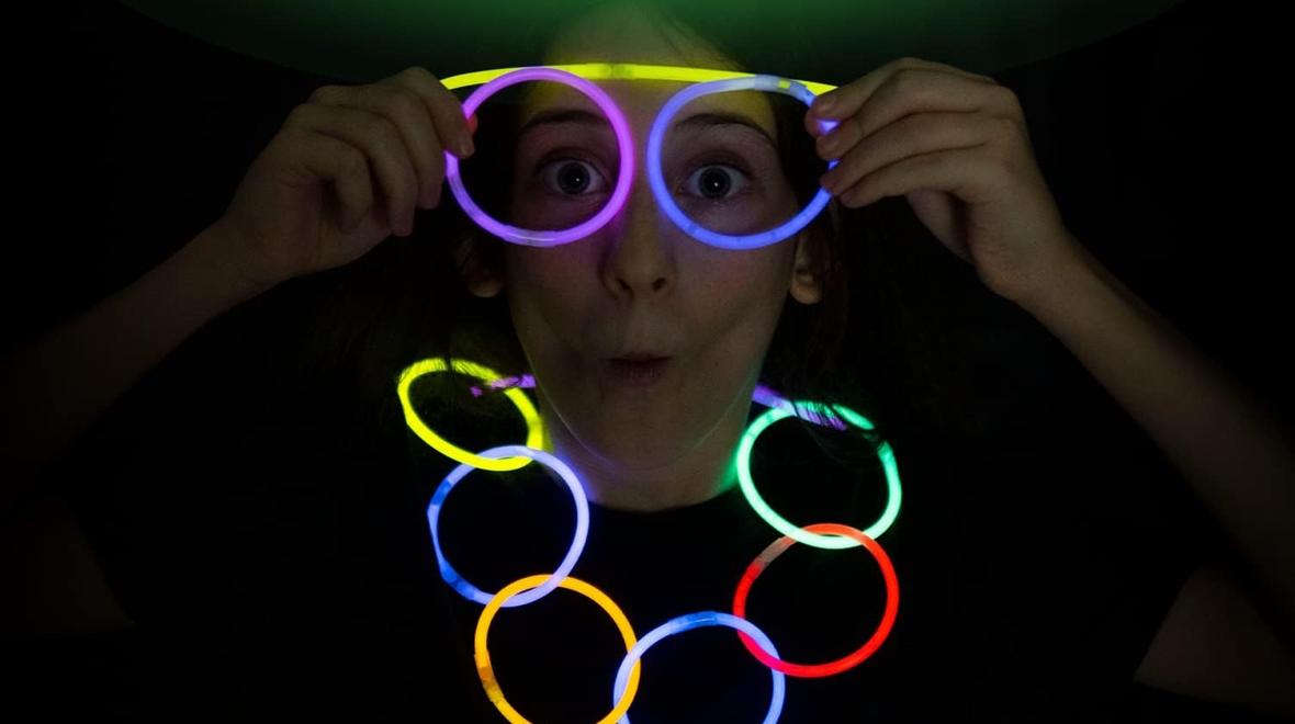 Girl with glow sticks on her eyes and as a necklace