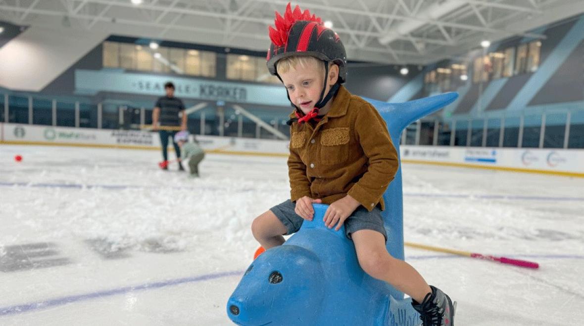 child playing on the ice at the Kraken community iceplex