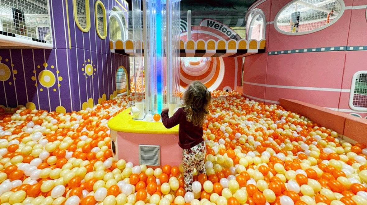 young girl playing in the ball pit at Twinkle Land Play Cafe in Bellevue
