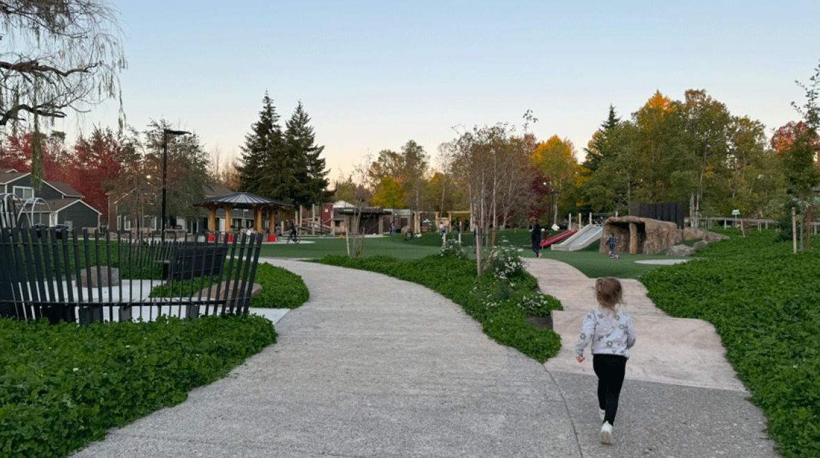 young girl playing on the playground at Pathways Park