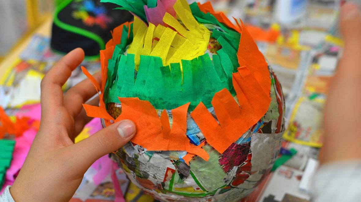 child making an egg shaped pinata for Easter