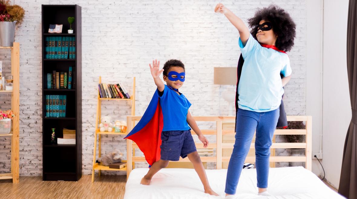 kids dressed in superhero capes and masks