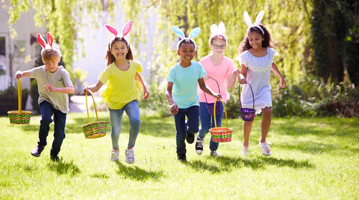 kids wearing bunny ears running and holding Easter baskets