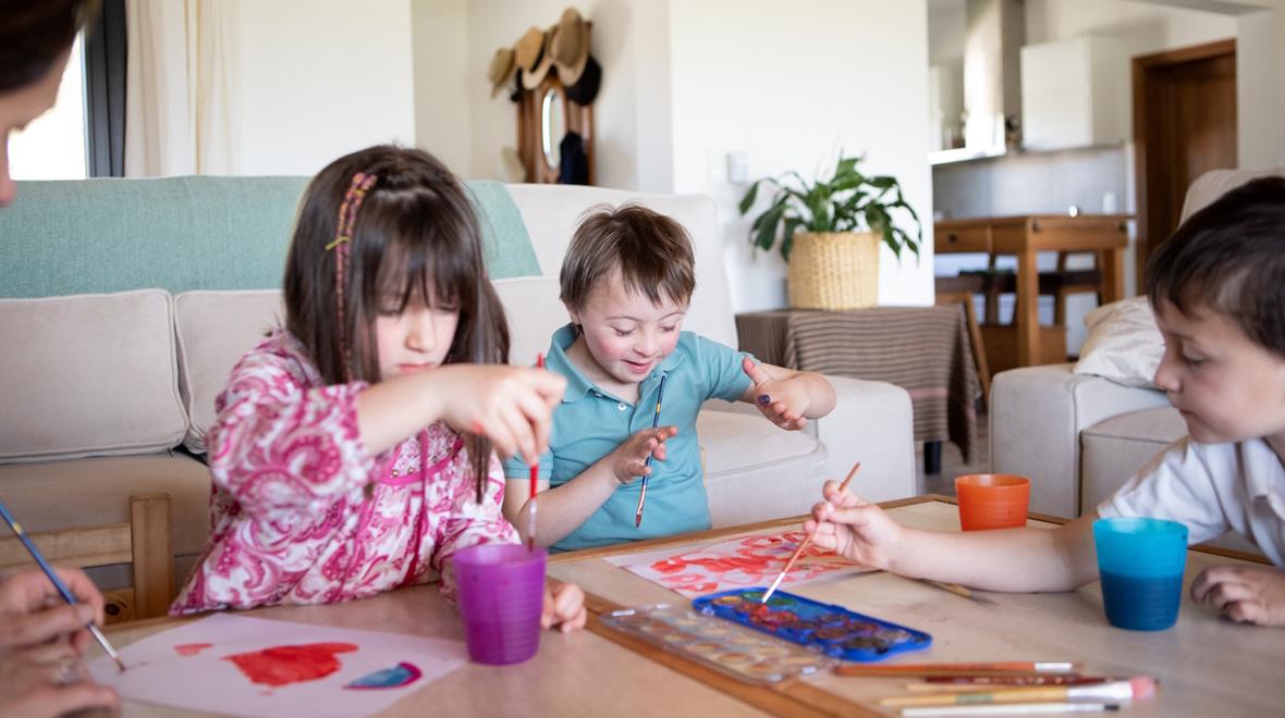 kids painting in the living room, a great activate for creative kids in the summer