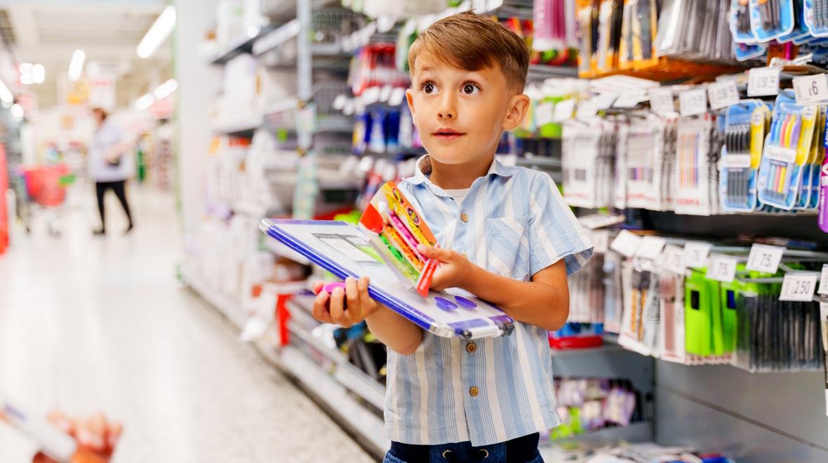 little boy shopping for school supplies