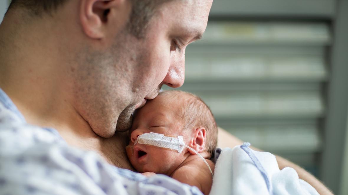 dad with infant in the hospital at a NICU