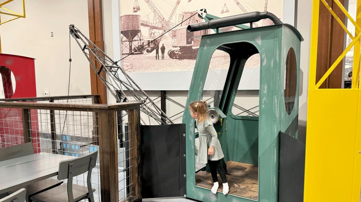 young preschooler operating a play crane at nick's magnificent