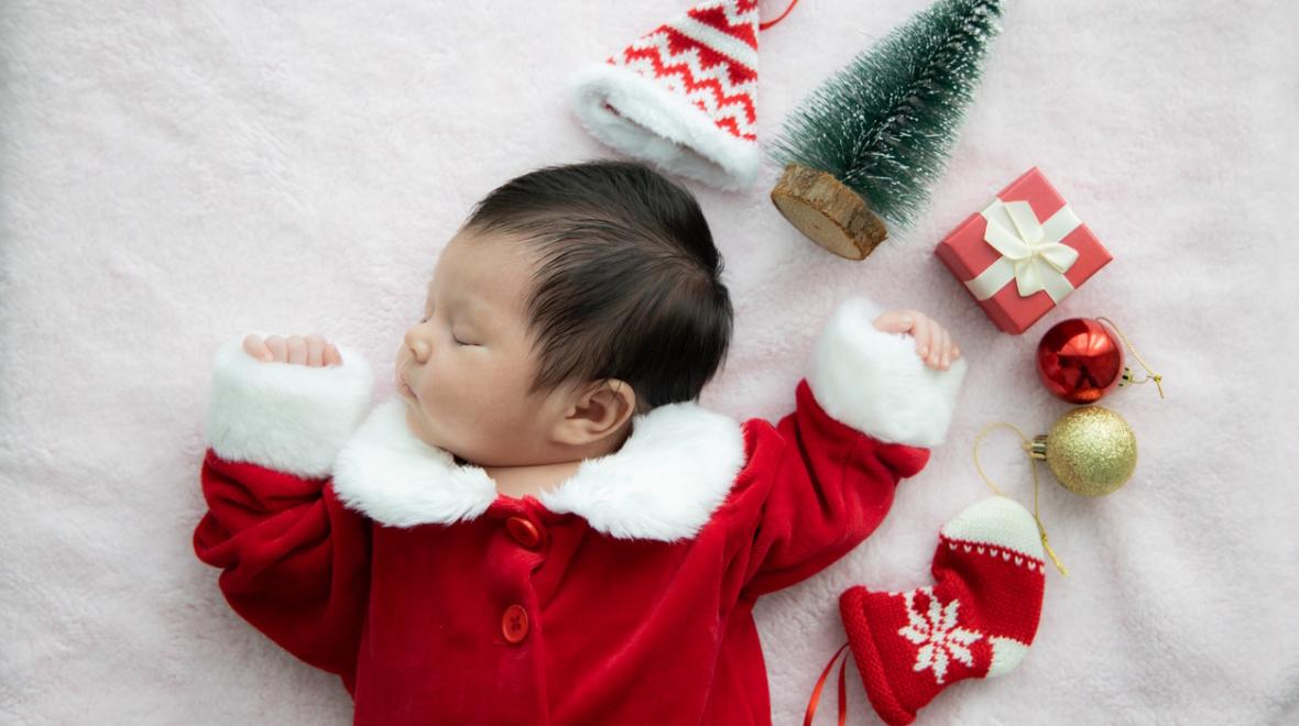 sleeping baby with holiday decorations 