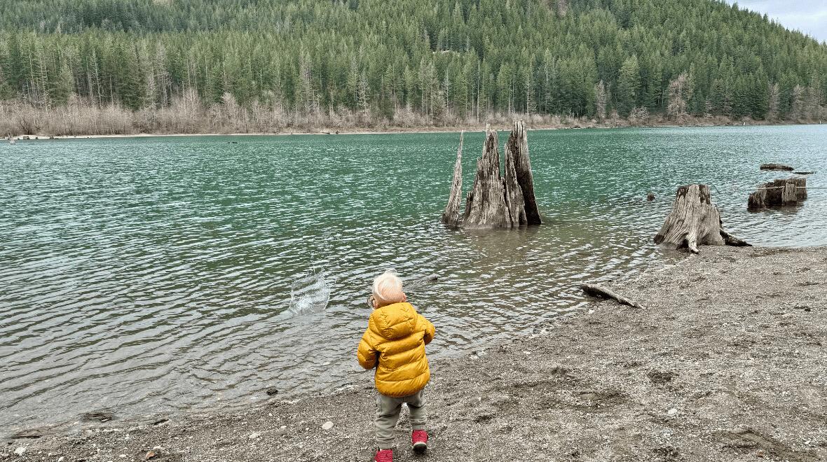boy playing at the edge of the cedar river