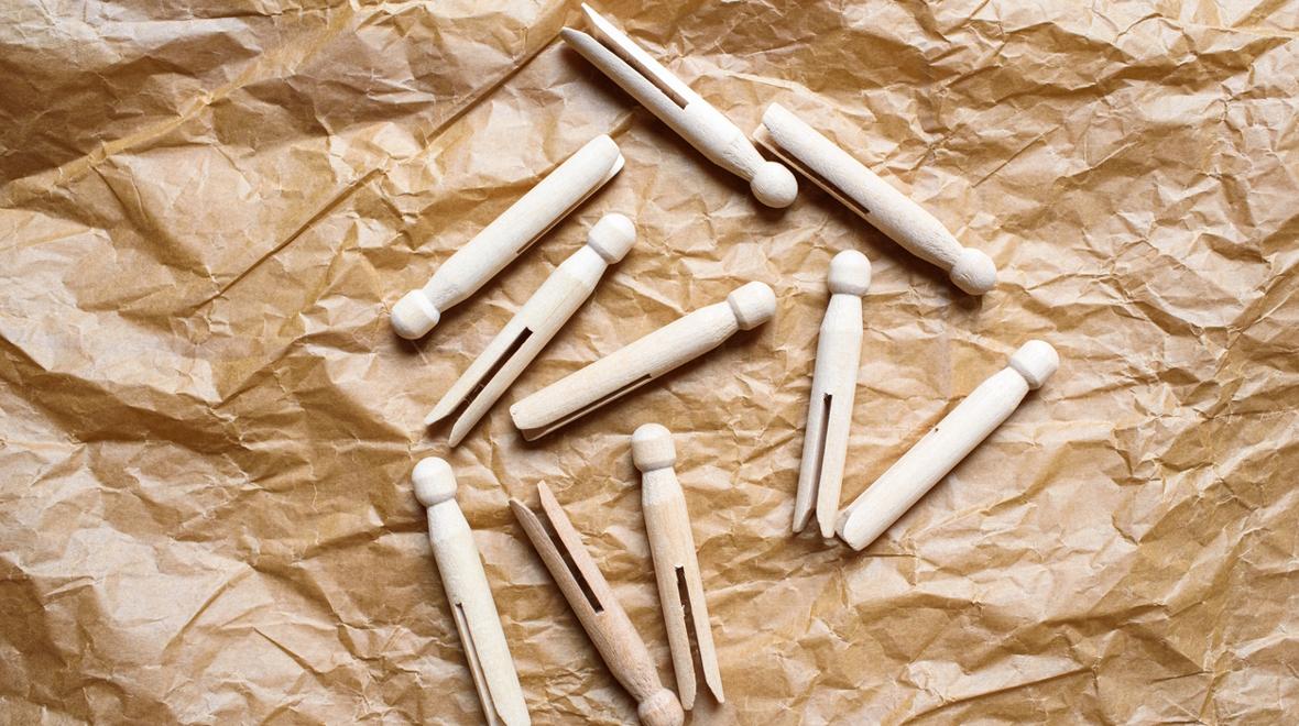 clothespins lying on a brown paper background