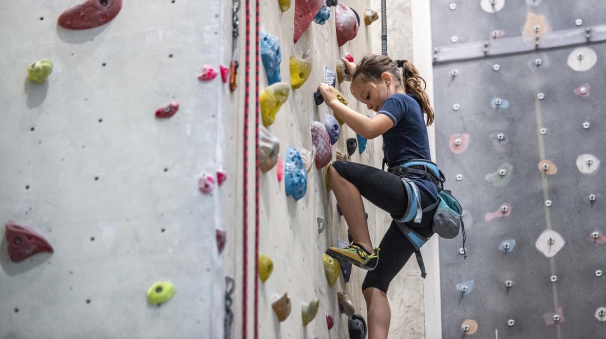 girl climbing in a rock climbing gym