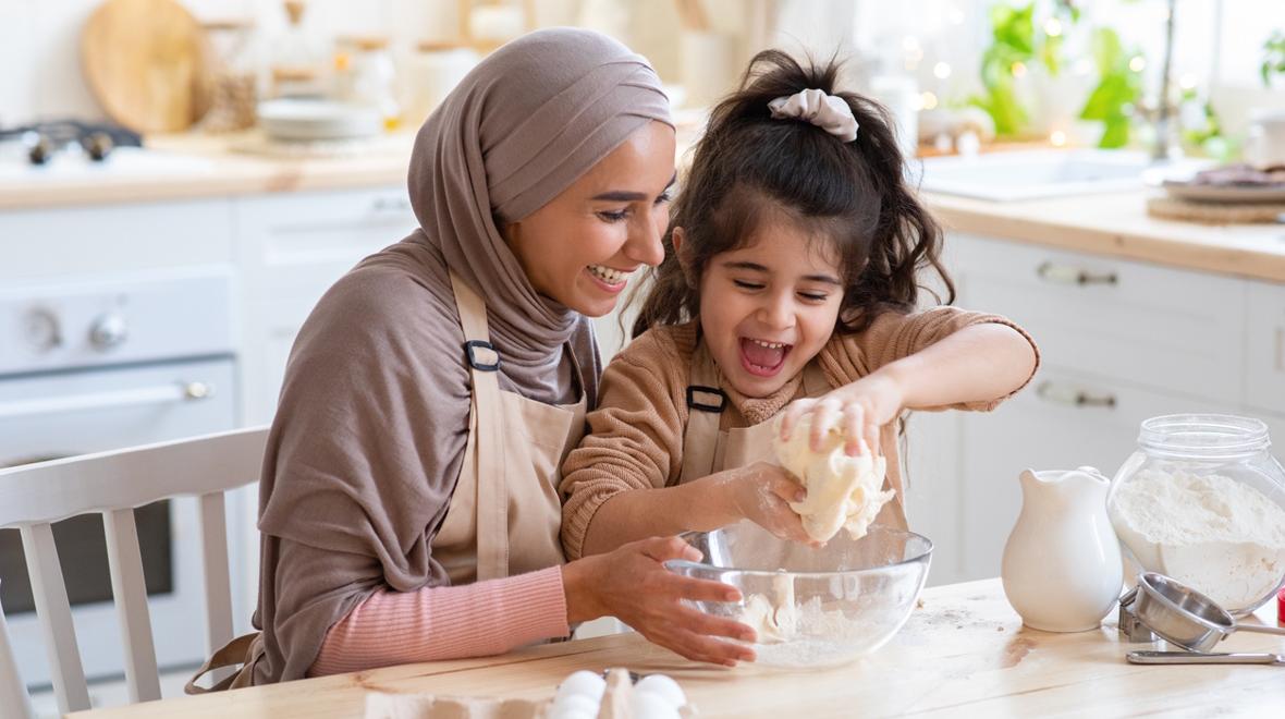 mom and daughter cooking together