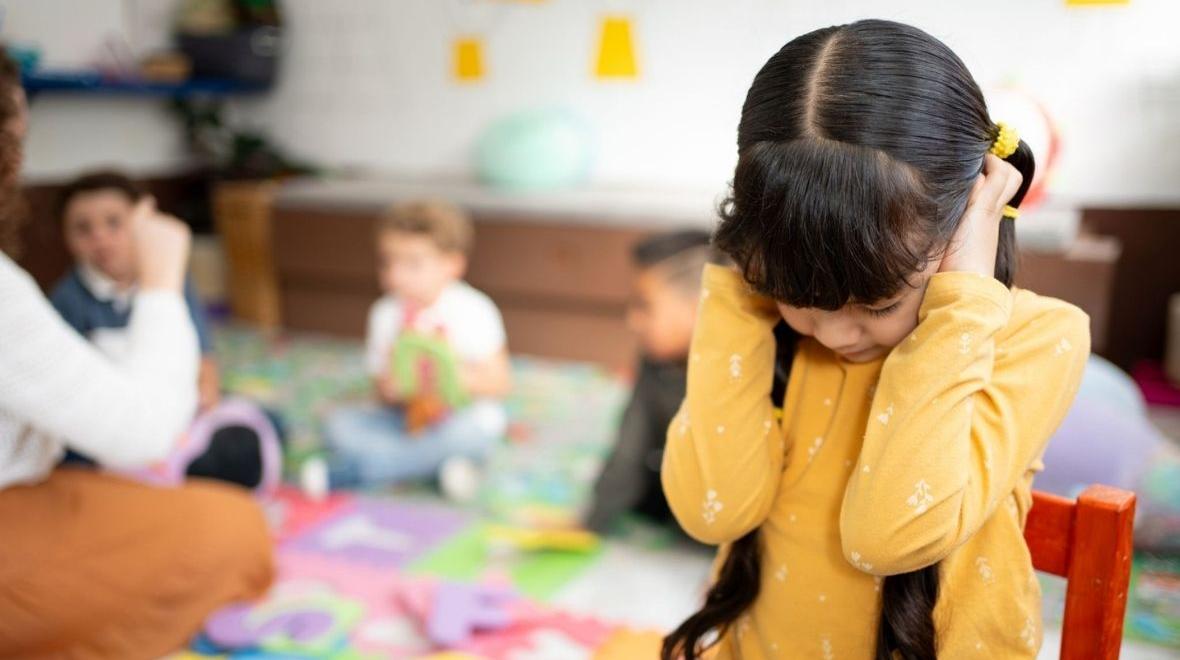 preschool girl frustrated covering her ears