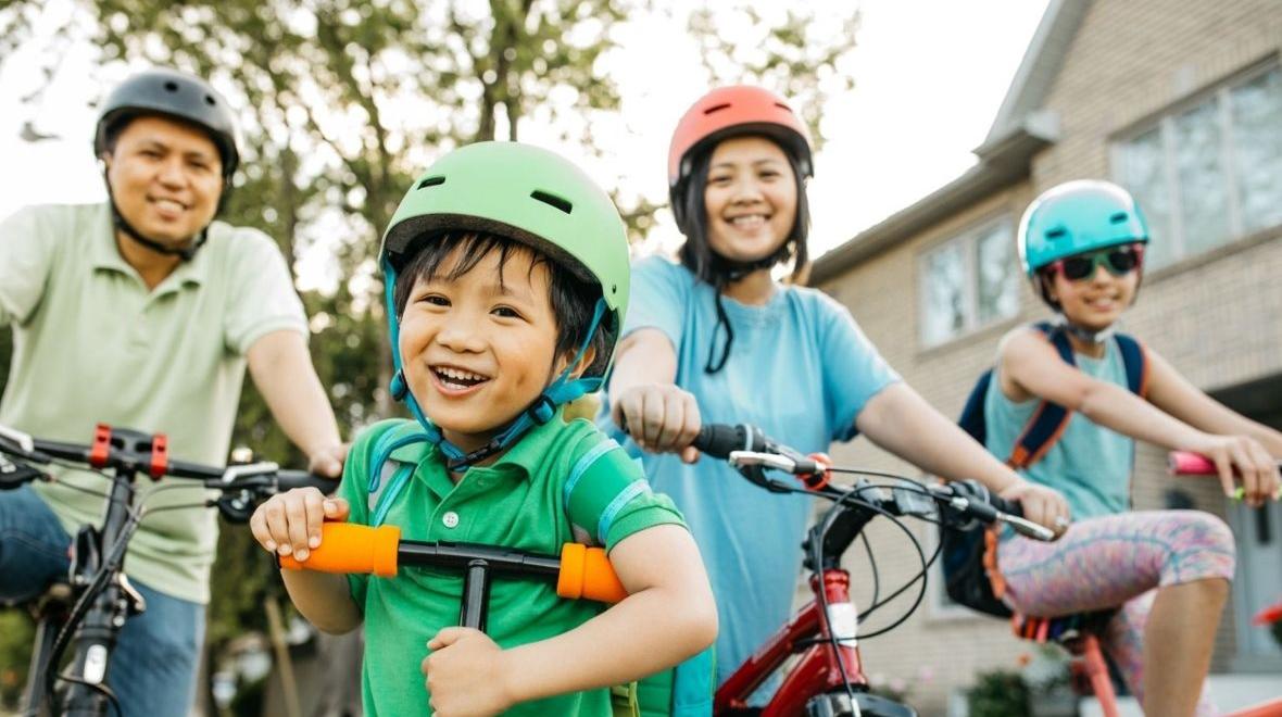 family biking outside in summers