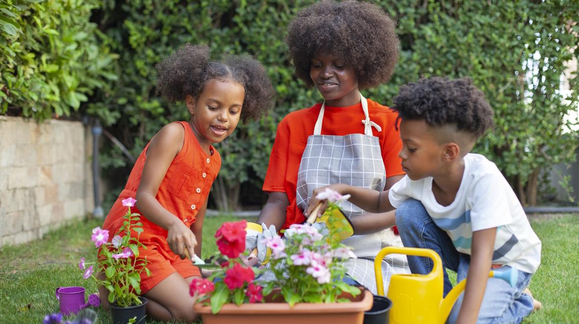 mom and kids planting flowers