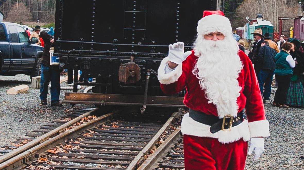 Santa next to a steam train at Mt. Rainier Scenic Railroad
