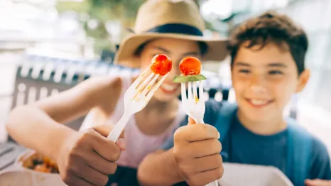 two kids with strawberries on sticks show of healthy lunch ideas for camp or travel
