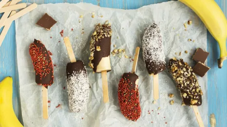 Frozen bananas covered in chocolate and sprinkles is a simple birthday party snack to make