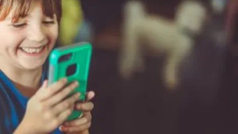 Cute laughing little girl using an alternative smartphone