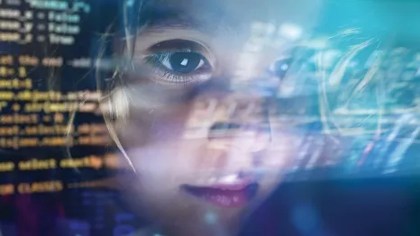 Young girl's face with reflections of computer screens