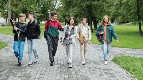 Group of teen kids walking down the street together 