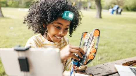 Young child doing an experiment at a STEAM and Science summer camp