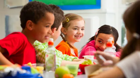 kids eating a healthy school lunch after new guidelines were implemented in washington