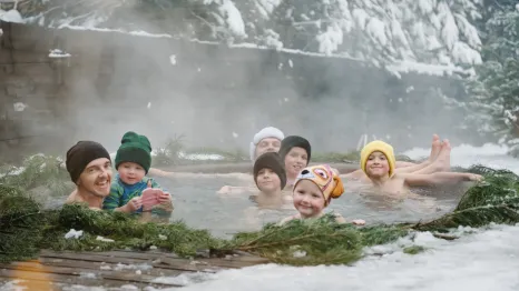 Adults and kids in a natural hot spring