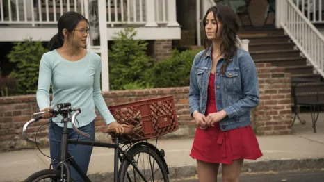 two girls walking on the sidewalk, a still image from the movie "The Half of It"