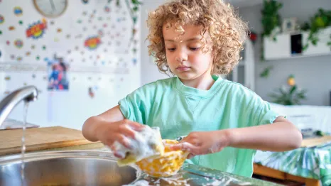 child washing dishes