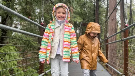 Kids walking across the suspension bridge at Bellevue Botanical Garden, a fun mid-winter break activity.