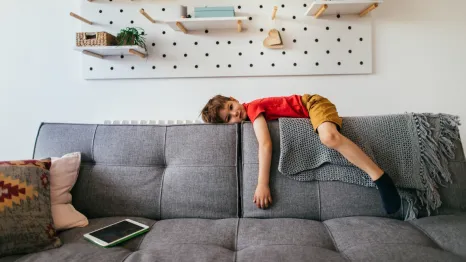 unmotivated child on the back of a couch