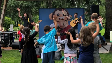 Kids dance along with band, Recess Monkey at a Seattle concert series in the summer