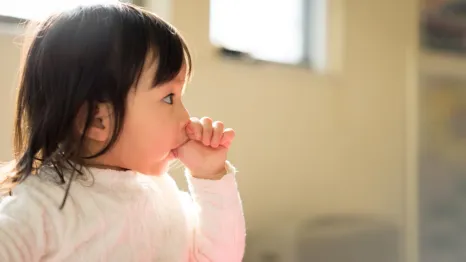 little girl sucking her thumb