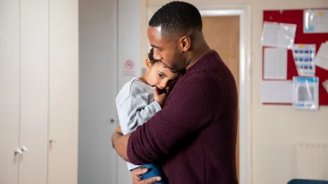 dad holding young son in the hospital