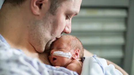 dad with infant in the hospital at a NICU