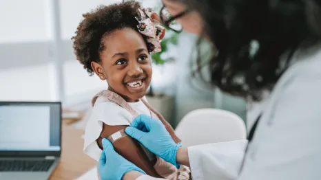Girl smiling after getting a vaccine shot