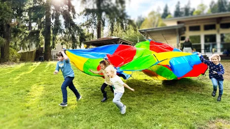 kids playing with a parachute at recess